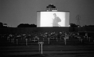 In this photo of the France Avenue Drive-in, ca. 1975, the top of the 24-story Wells Fargo building, once the tallest building in Bloomington, is visible behind the screen. 