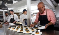 Andrew Zimmern prepares food for Taste Fore the Tour
