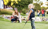 A child plays mini golf at Centennial Lakes Park