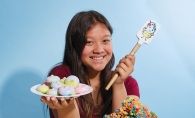 Kids Baking Championship contestant Meadow Roberts, founder of Sweet Meadow, holds some of her creations.