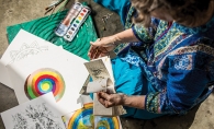 An artist paints in watercolor at the Edina Art Center