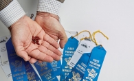 Russell Stanton holds seeds for his Minnesota State Fair blue ribbon-winning squash