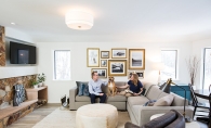 Jeff and Leslie Nicholson, founders of Quartersawn Design Build, sit with their dog in their remodeled home.