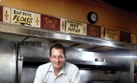  Tony Rimarcik, son of Convention Grill owner John Rimarcik, serves up the diner’s most popular meal: cheeseburger, fries and a malted milk.