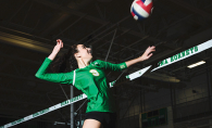 An athlete on the Edina High School volleyball team jumps for a spike.