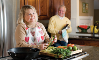 Edina resident Sandra Wakefield prepares zucchini noodles in her kitchen while her husband looks on.