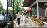 Two women walk through 50th & France.