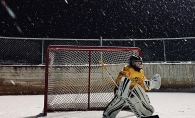 Child goalie in front of hockey net