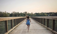 A woman runs on the 9 Mile Creek Regional Trail near Walnut Ridge Park.