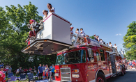An Edina Fire Department truck rolls down the road as part of the Fourth of July parade.