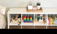 Children's toys sit organized on a set of shelves, thanks to Style + Dwell.