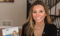 Jacqueline Hanson holds a copy of her first novel, "A Place in Time"