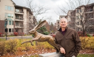 Nick Legeros standing by one of his bronze sculpture 