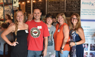 Attendees of Reach for Resources' yearly fundraiser, Reach On Tap, pose for a photo at Wooden Hill Brewing Company.