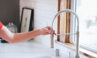 A home inspector checks out a faucet.