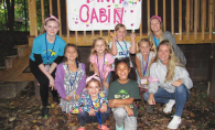 Campers at Camp Erin pose in front of their "Pink Cabin"