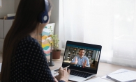 Young female student consulting online with teacher