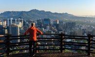 A high school student from an exchange program looks at the skyline in Seoul, South Korea.