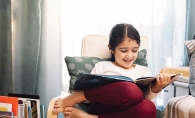 Young girl reading a picture book