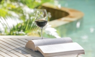 drinking wine while reading on patio