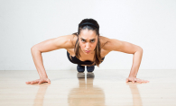 A woman prepares for a perfect push up.