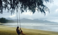 A woman sits on a swing on Klong Prao Beach