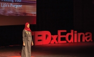 TEDxEdina speaker Nausheena Hussain on stage.