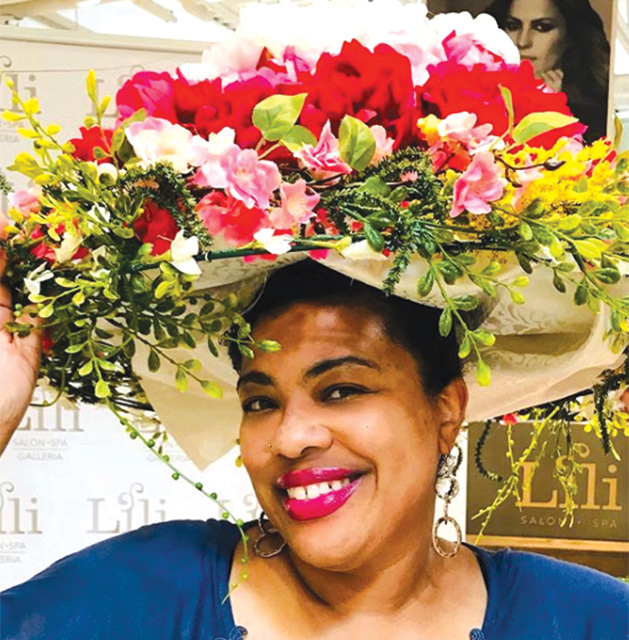 Minneapolis blogger Stacie Raye models a flower hat at the Galleria Garden Party.