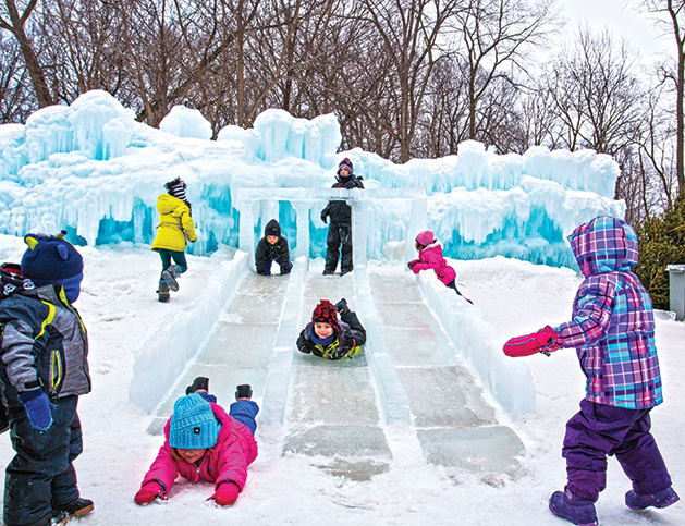 Children slide on a frozen Minnesota lake.