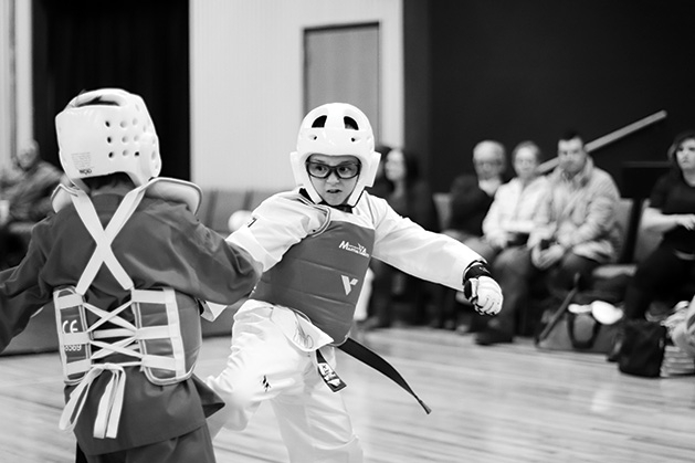 Two fencers face off in a black and white photo.
