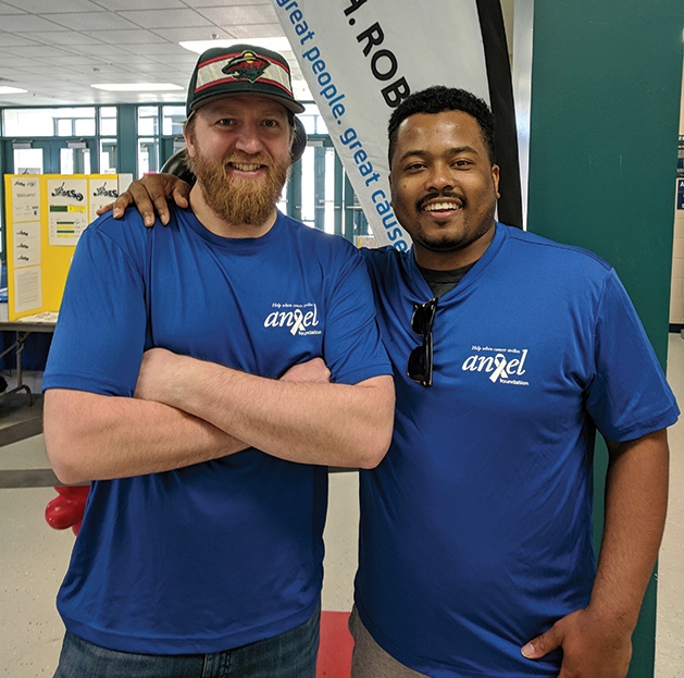 Two men pose for a photo at the 2019 Big Futures Tournament and Family Festival