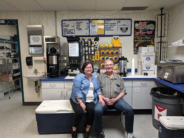 A woman and man sit at the concession stand at the 2019 Big Futures Tournament and Family Festival.