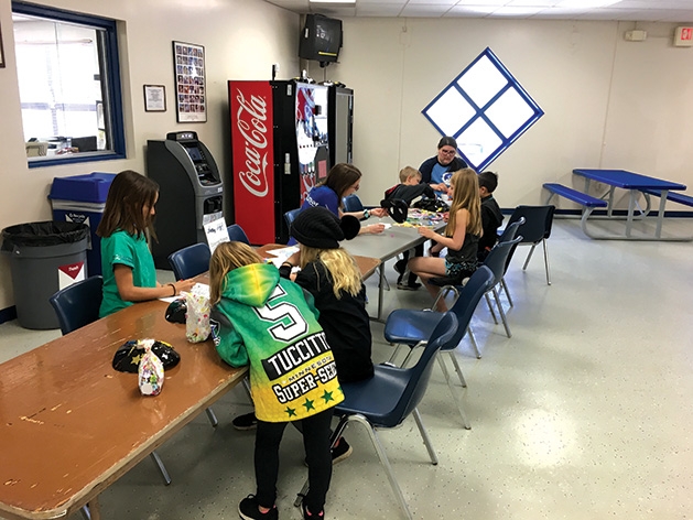 A family gathers at a table at the 2019 Big Futures Tournament and Family Festival.