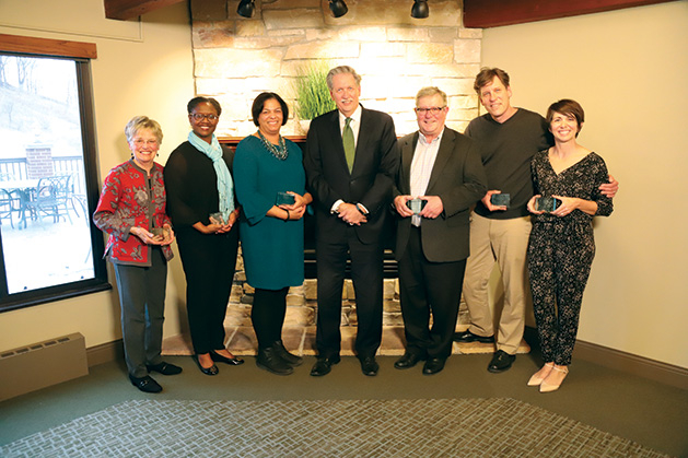 A group of volunteers pose with their awards.