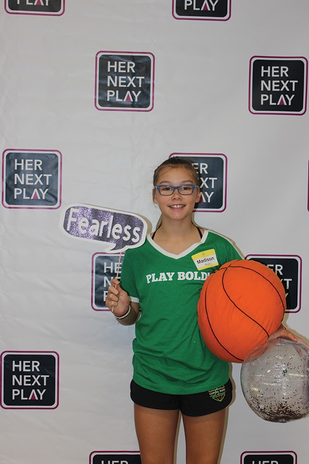 A girl poses for a photo at the Girls' Sports Summit