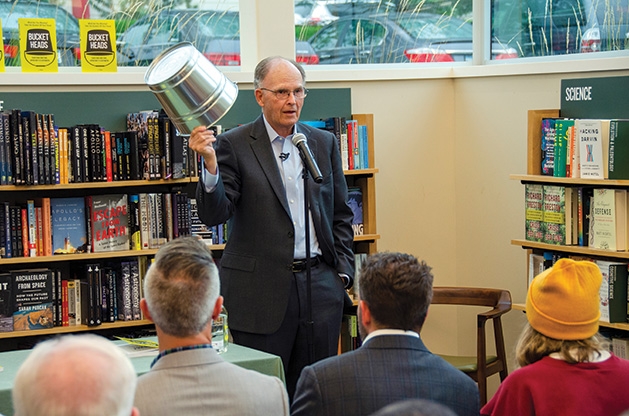 J. Allen holds a bucket at his book signing.