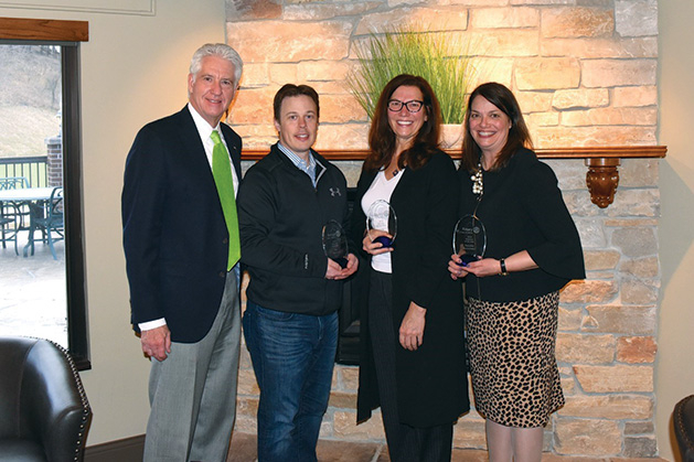 Volunteers pose with their awards.