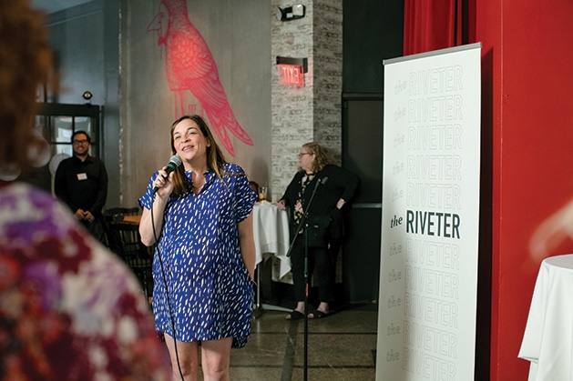 A woman speaks at the grand opening of The Riveter co-working space in Edina.
