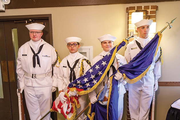 Four U.S. Naval Sea Cadets hold the American and Minnesotan flags