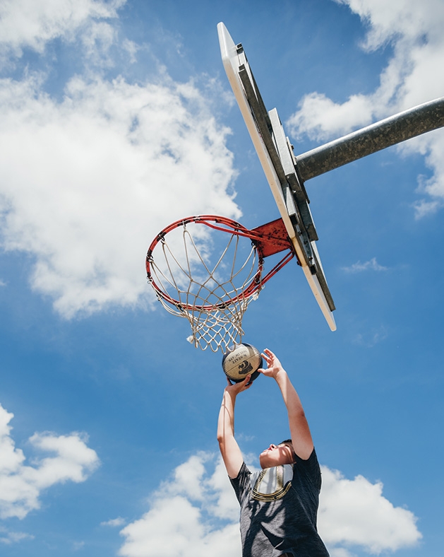 A boy shoots a basketball at Cornelia Field Day