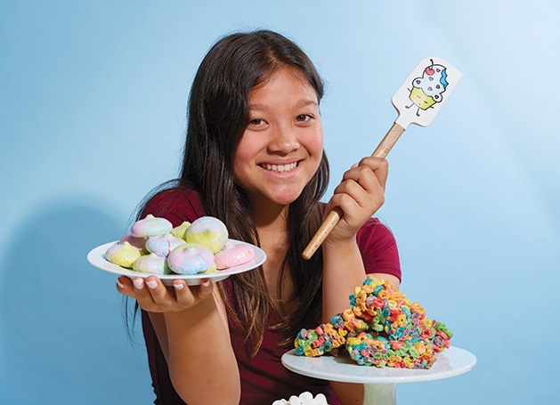 Kids Baking Championship contestant Meadow Roberts, founder of Sweet Meadow, holds some of her creations.