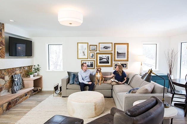 Jeff and Leslie Nicholson, founders of Quartersawn Design Build, sit with their dog in their remodeled home.