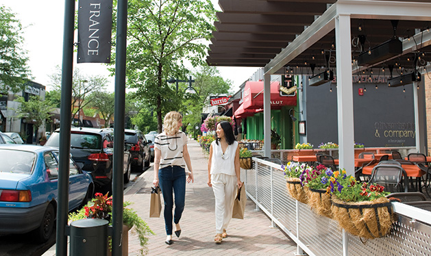 Two women walk through 50th & France.