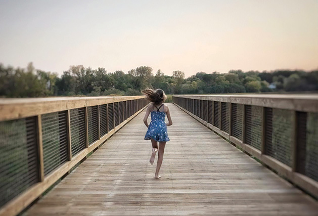 A woman runs on the 9 Mile Creek Regional Trail near Walnut Ridge Park.