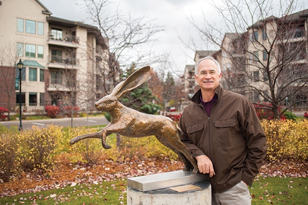 Nick Legeros standing by one of his bronze sculpture 