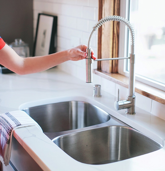 A home inspector checks out a faucet.