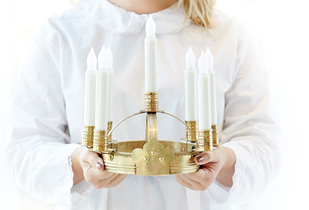 American Swedish Institute St. Lucia concert A woman holds a crown of candles for the St. Lucia concert at the American Swedish Institute