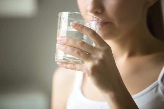 Woman drinking water.