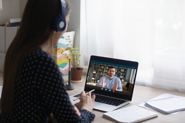 Young female student consulting online with teacher