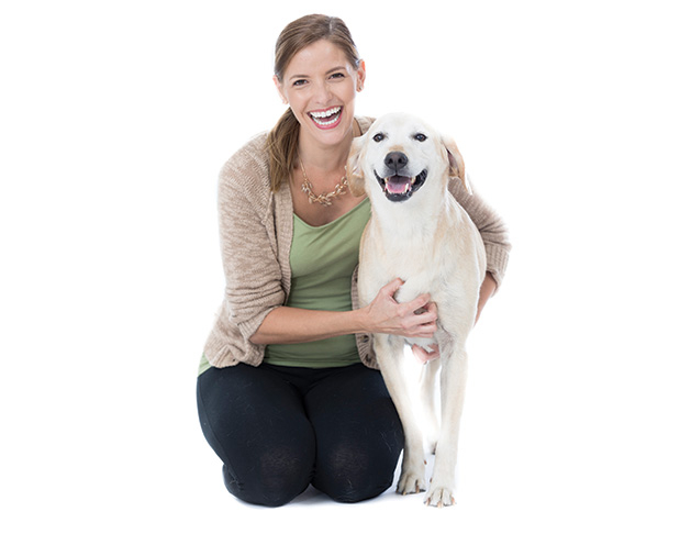 A woman embraces her dog.